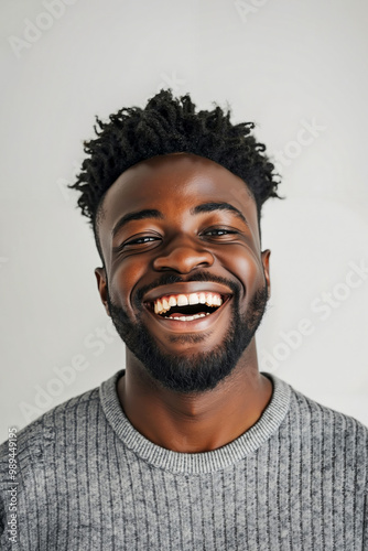 A man with a beard smiles at the camera