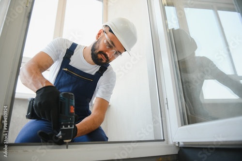 Young man repairing a terrace door