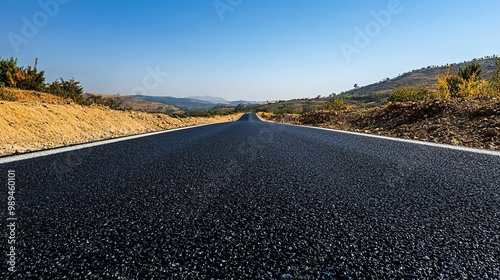 A well-maintained asphalt road extends beneath a clear sky