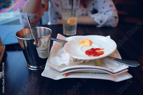 The setting beautifully showcases a partially finished meal featuring various dips and a refreshing drink