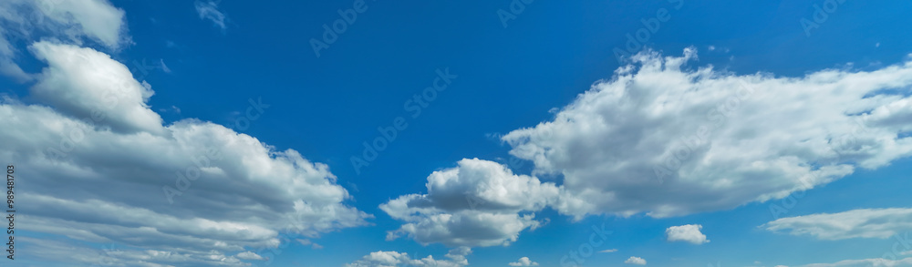 A serene sky with fluffy white clouds and a bright blue backdrop, capturing the essence of a beautiful day A serene sky with fluffy white clouds and a bright blue backdrop, capturing the essence of a beautiful day