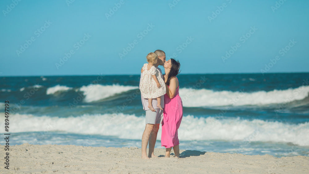 Happy parents carrying little doughter at beach Happy parents carrying little doughter at beach