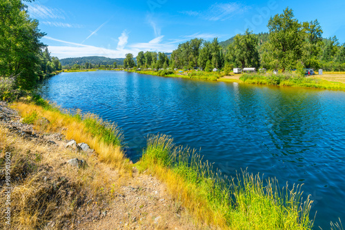 Fototapeta Naklejka Na Ścianę i Meble -  The Coeur d'Alene River as it runs under the Canyon Road Bridge in the rural Silver Valley town of Cataldo, Idaho, panhandle region near Coeur d'Alene.