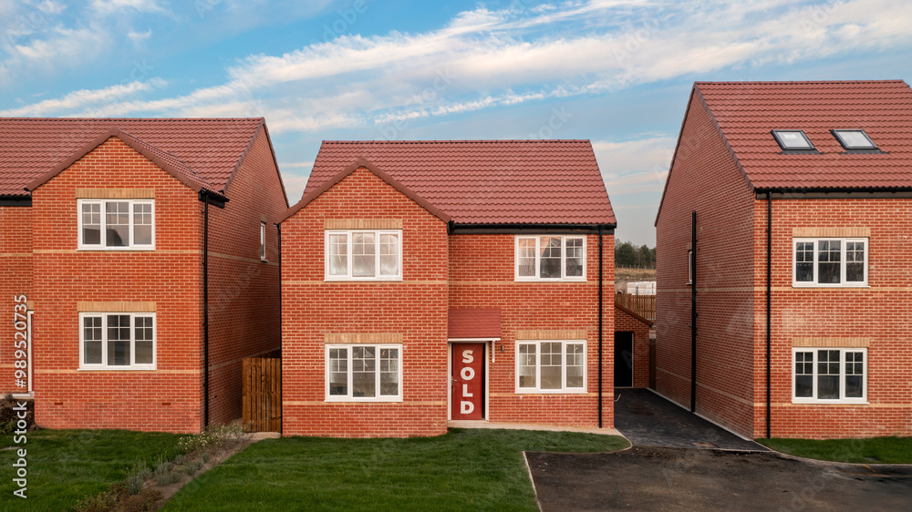 A row of new build homes with sold sign A row of new build homes with sold sign