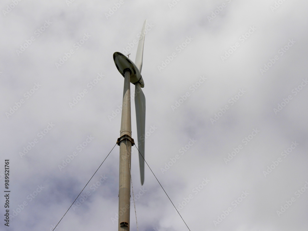 two blade wind turbine and cloudy sky, wind power and clean energy concept two blade wind turbine and cloudy sky, wind power and clean energy concept