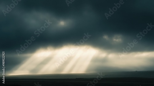  weak sunlight barely breaking through thick, grey clouds on an autumn day