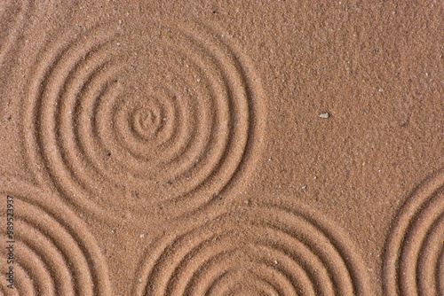 Lines drawn in brown sand background, beautiful sand texture, overhead view of chocolate brown sand, zen pattern drawn in the sand, Top view of fine grain texture