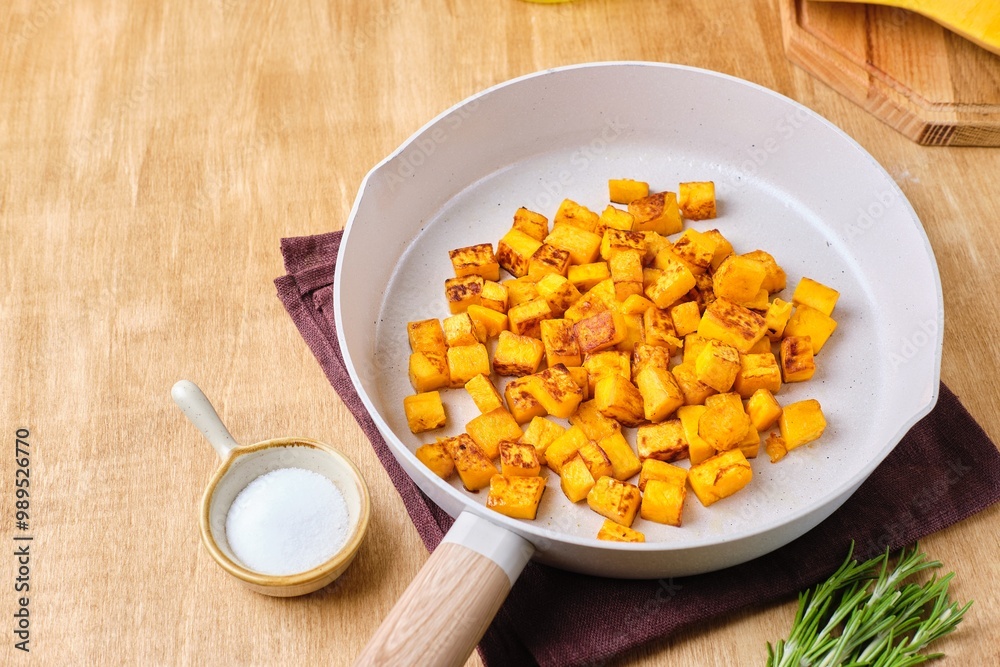 Preparing the filling for pumpkin ravioli or salad, fried pumpkin pieces in a light frying pan. Preparing the filling for pumpkin ravioli or salad, fried pumpkin pieces in a light frying pan.