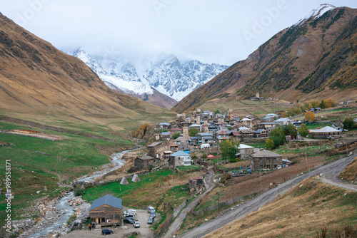 Obraz na plátně A panoramic view of Ushguli village nestled in a mountain valley with a river running through