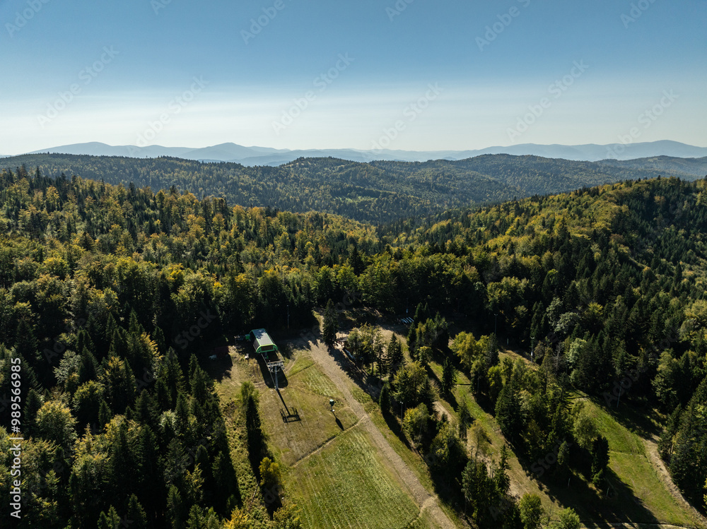 Obraz premium Beskid Maly aerial panorama of potrojna hill and czarny gron.Little Beskids mountain range in summer.Aerial drone view of Rzyki Village in Beskid Maly Poland.Czarny gron ski resort in Rzyki.