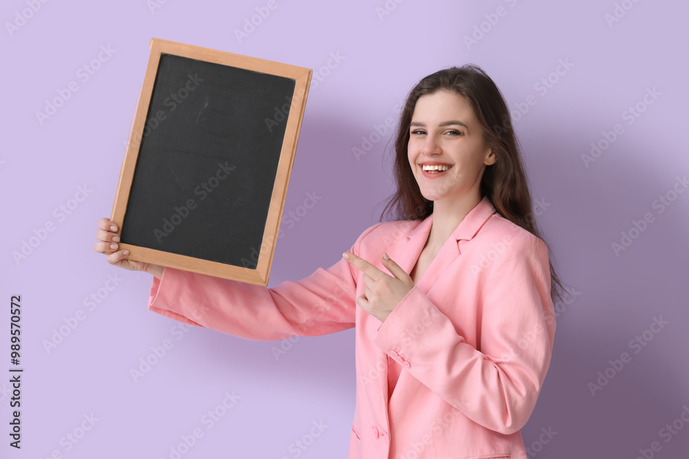 Female teacher pointing at chalkboard on lilac background Female teacher pointing at chalkboard on lilac background