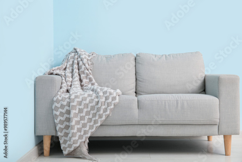 Grey sofa with cozy blanket...