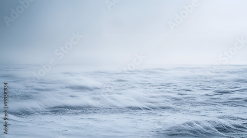 A snowstorm sweeping across a barren plain with visibility reduced to a few feet as the snow swirls violently in the wind. photo