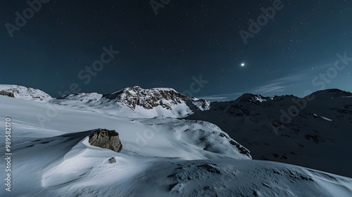 Obraz na płótnie A snowy mountain ridge illuminated by the soft glow of the moon with shadows stretching across the untouched snow and the stars twinkling above. w salonie