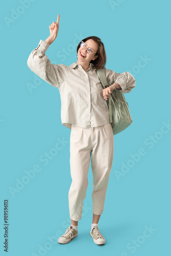 Happy female student with b...
