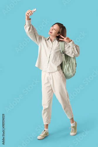 Happy female student with b...