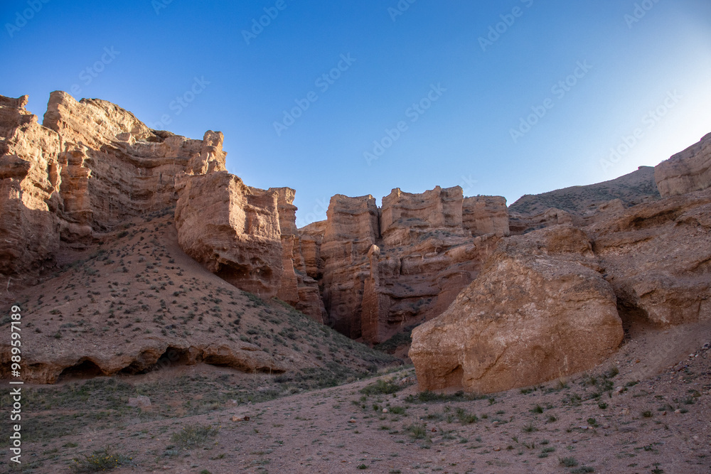 A stunning Charyn canyon in the desert beneath a bright blue sky
