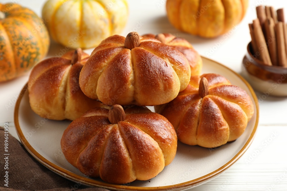 Tasty pumpkin shaped buns and ingredients on white wooden table, closeup Tasty pumpkin shaped buns and ingredients on white wooden table, closeup