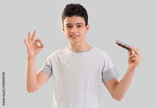 Teenage boy with harmonica ...