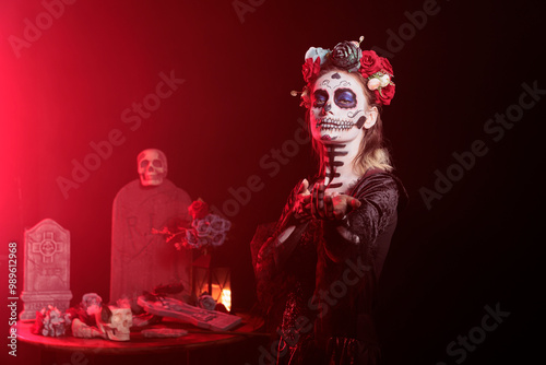 Fotografie Portrait of woman doing enticing invitation hand gesture for Day of the Dead Mexican celebration