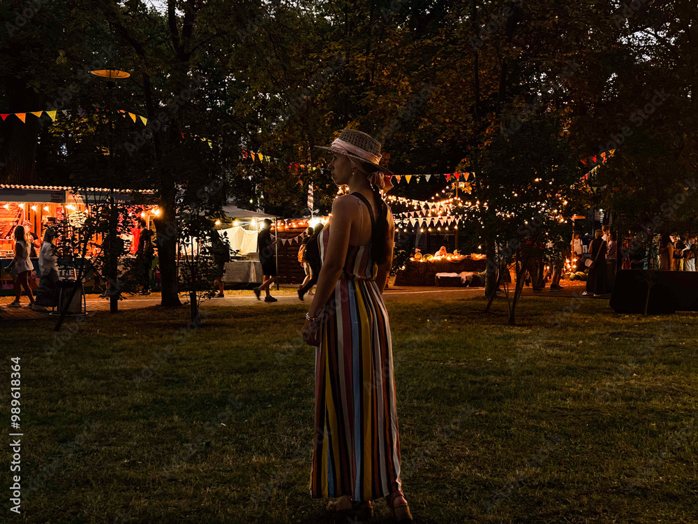 mother with daughter at carnival, food fest festival, food holiday, night carnival, woman in hat looking at city lights mother with daughter at carnival, food fest festival, food holiday, night carnival, woman in hat looking at city lights