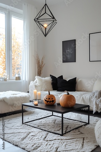 Contemporary Halloween living room with stark black furniture and pumpkin displays.