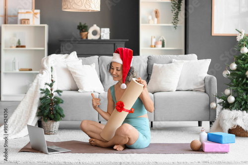 Happy woman in santa hat ho...
