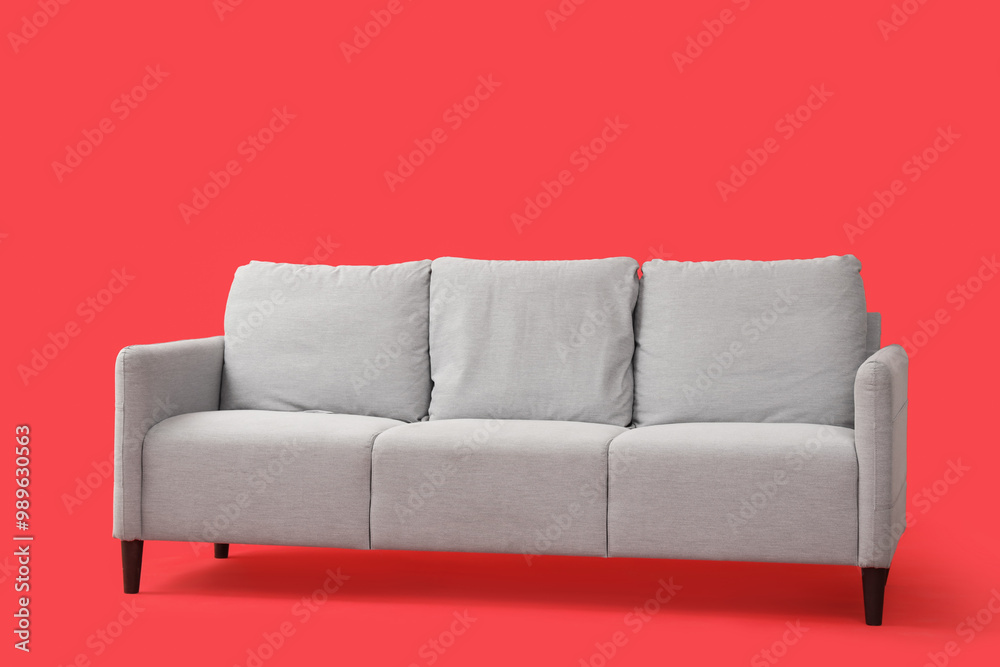 Fototapeta premium Grey sofa on red background