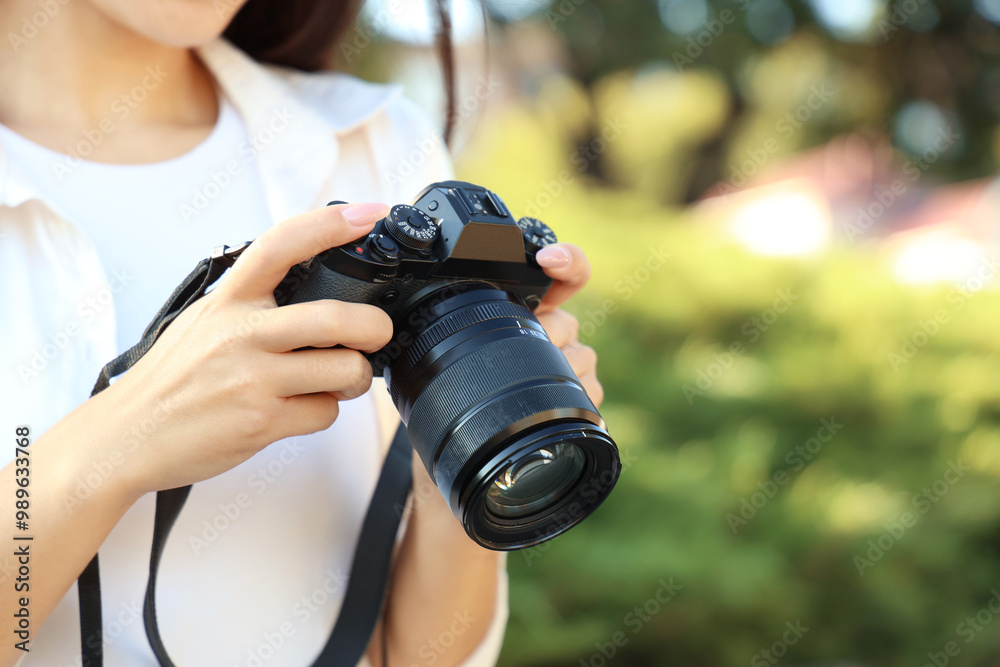 Female photographer with camera in park, closeup Female photographer with camera in park, closeup