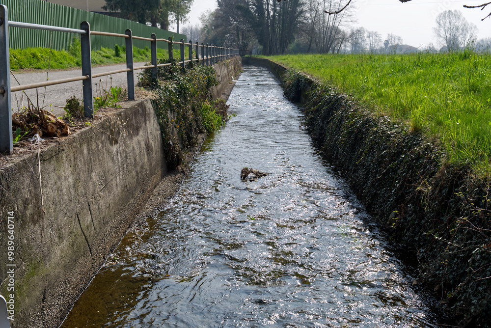 an agricultural irrigation canal runs alongside a field an agricultural irrigation canal runs alongside a field