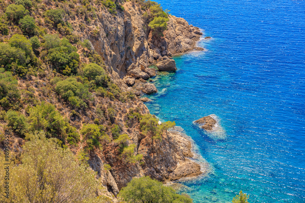 A rocky shoreline with a blue ocean in the background A rocky shoreline with a blue ocean in the background