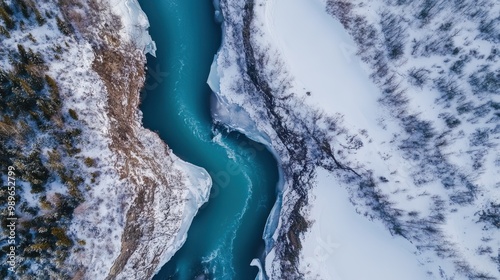 Aerial view of a winding river through snowy landscapes and icy formations.