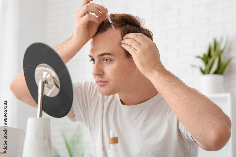Young redhead man making himself injection for hair growth at home Young redhead man making himself injection for hair growth at home