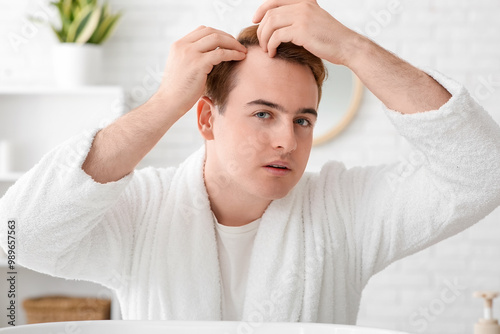 Young redhead man with hair...
