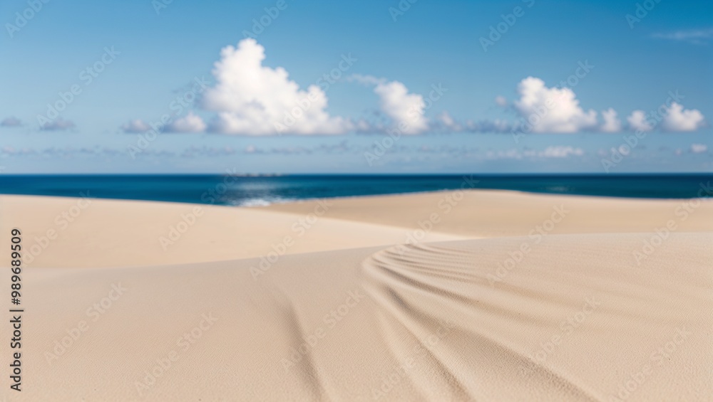The foreground is dominated by smooth, light beige sand with gentle undulations, creating a sense of calm and tranquility The foreground is dominated by smooth, light beige sand with gentle undulations, creating a sense of calm and tranquility