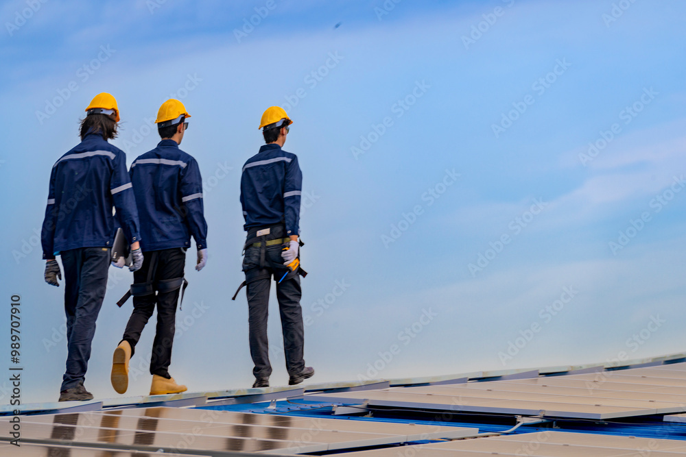 Worker Technicians are working to construct solar panels system on roof. Installing solar photovoltaic panel system. Men technicians walking on roof structure to check photovoltaic solar modules. Worker Technicians are working to construct solar panels system on roof. Installing solar photovoltaic panel system. Men technicians walking on roof structure to check photovoltaic solar modules.