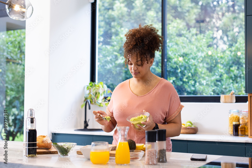 Preparing healthy meal, woman spreading avocado on toast in kitchen, at home, at home Preparing healthy meal, woman spreading avocado on toast in kitchen, at home, at home