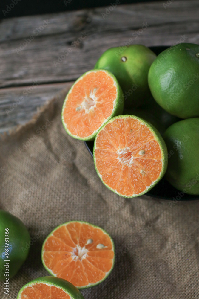 Fresh orange fruits on dark background. Citrus juicer. Summer tropical fruits. Food concept. Creative background Fresh orange fruits on dark background. Citrus juicer. Summer tropical fruits. Food concept. Creative background