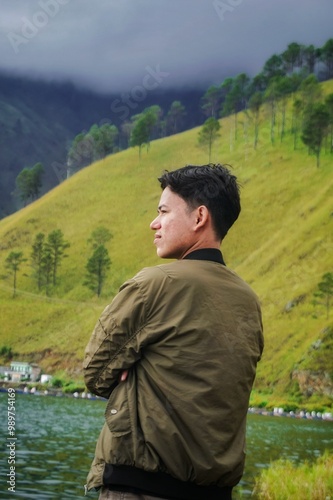 Portrait of a Southeast Asian youth enjoying the cool nature of the hills in Paropo Silalahi, North Sumatra, Indonesia photo