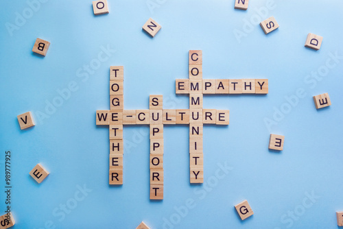 Crossword We-Culture made of wooden blocks with letters. Concept of the culture of community, company and teamwork. Selective focus photo