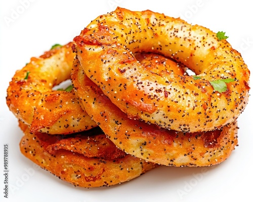 Savory, spiced circular snacks piled together, showcasing a crispy texture and a golden-brown hue with a sprinkle of seasoning. photo