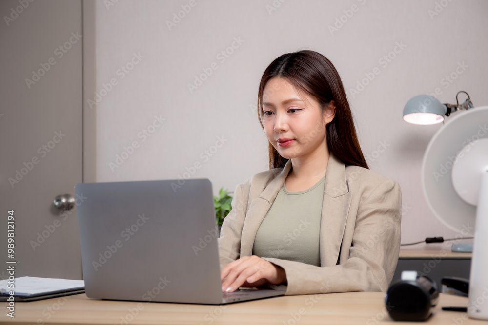 Young asian woman sitting and using laptop computer planning for success in modern office, businesswoman typing and watching notebook with confident, employee working on desk, business concept. Young asian woman sitting and using laptop computer planning for success in modern office, businesswoman typing and watching notebook with confident, employee working on desk, business concept.