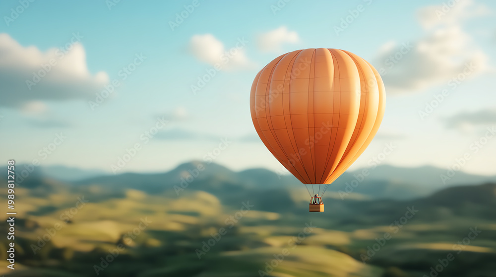 Obraz premium A vibrant orange hot air balloon gently floats over lush green hills under a clear blue sky, capturing the essence of peaceful adventure.