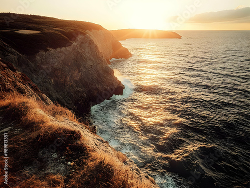 Breathtaking coastal view during sunset, cliffs meeting the ocean, warm colors illuminating the horizon. photo