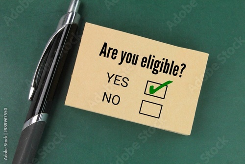 Photography pen and paper with the question Are you eligible? the concept of choice or chose