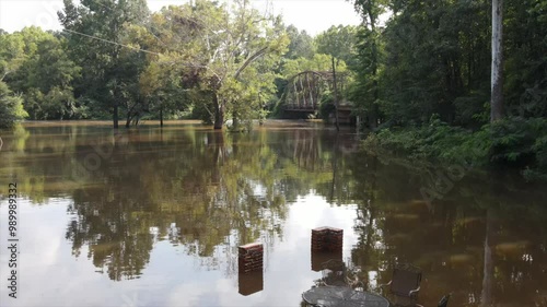 Flooded river by old iron bridge photo