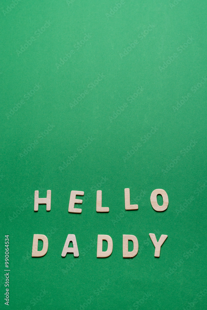 Obraz premium poster with letters forming the words hello daddy, green background