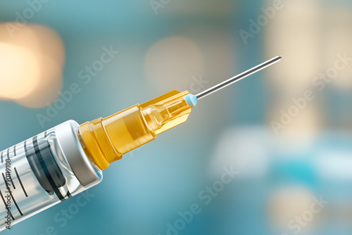 A close-up shot of the syringe being inserted into an overhead vial, with focus on its sharp tip and visible needle in motion.  photo