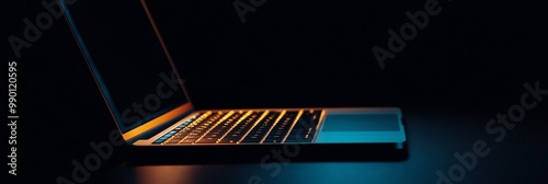 Black laptop with glowing keys on a dark background, symbolizing technology, innovation, connectivity, productivity, and future.