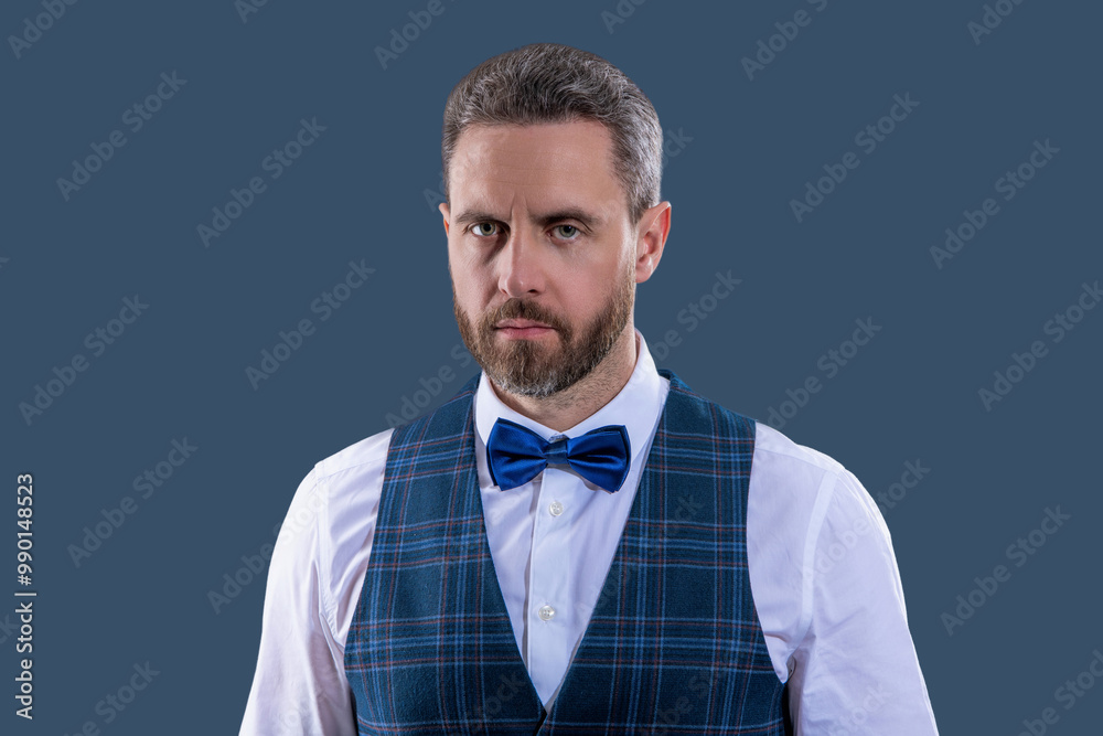 Handsome charismatic waiter man wear tux elegant bowtie ready to serve in classic uniform isolated on grey Handsome charismatic waiter man wear tux elegant bowtie ready to serve in classic uniform isolated on grey